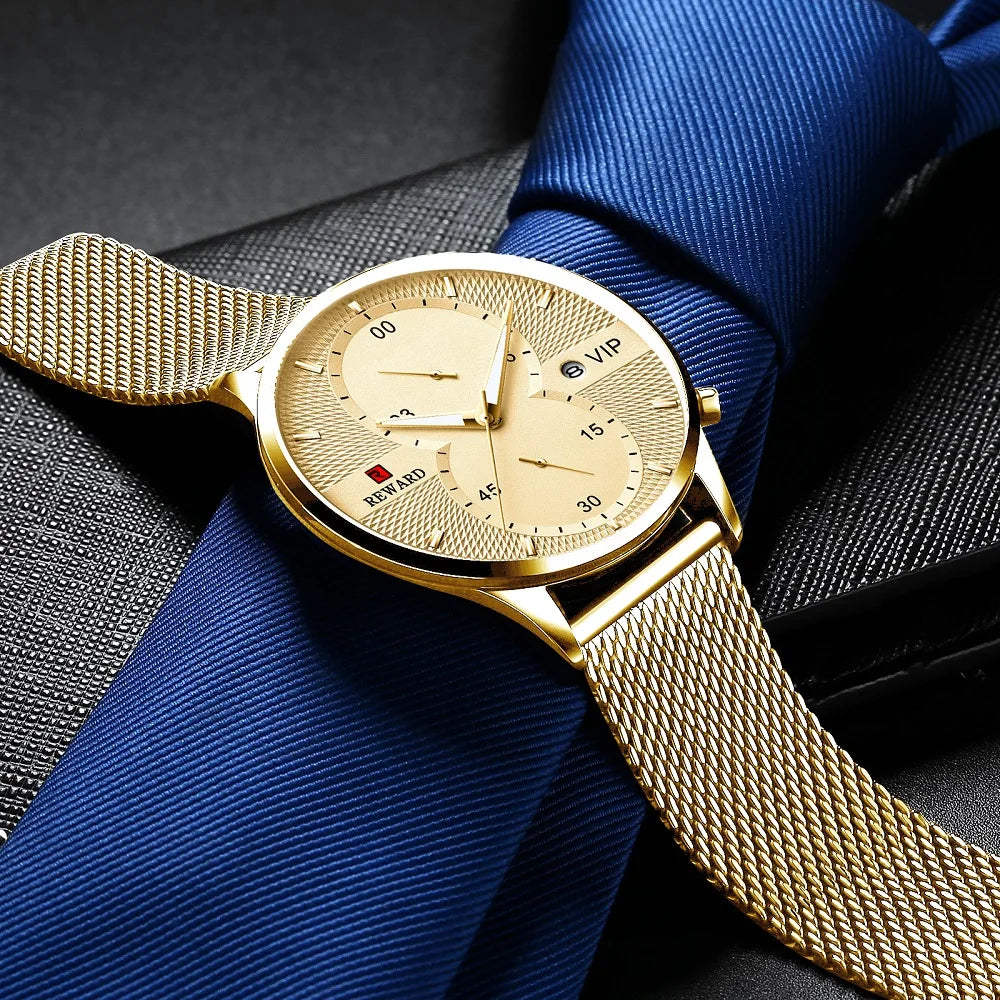 Gold watch with a mesh band on a blue fabric background
