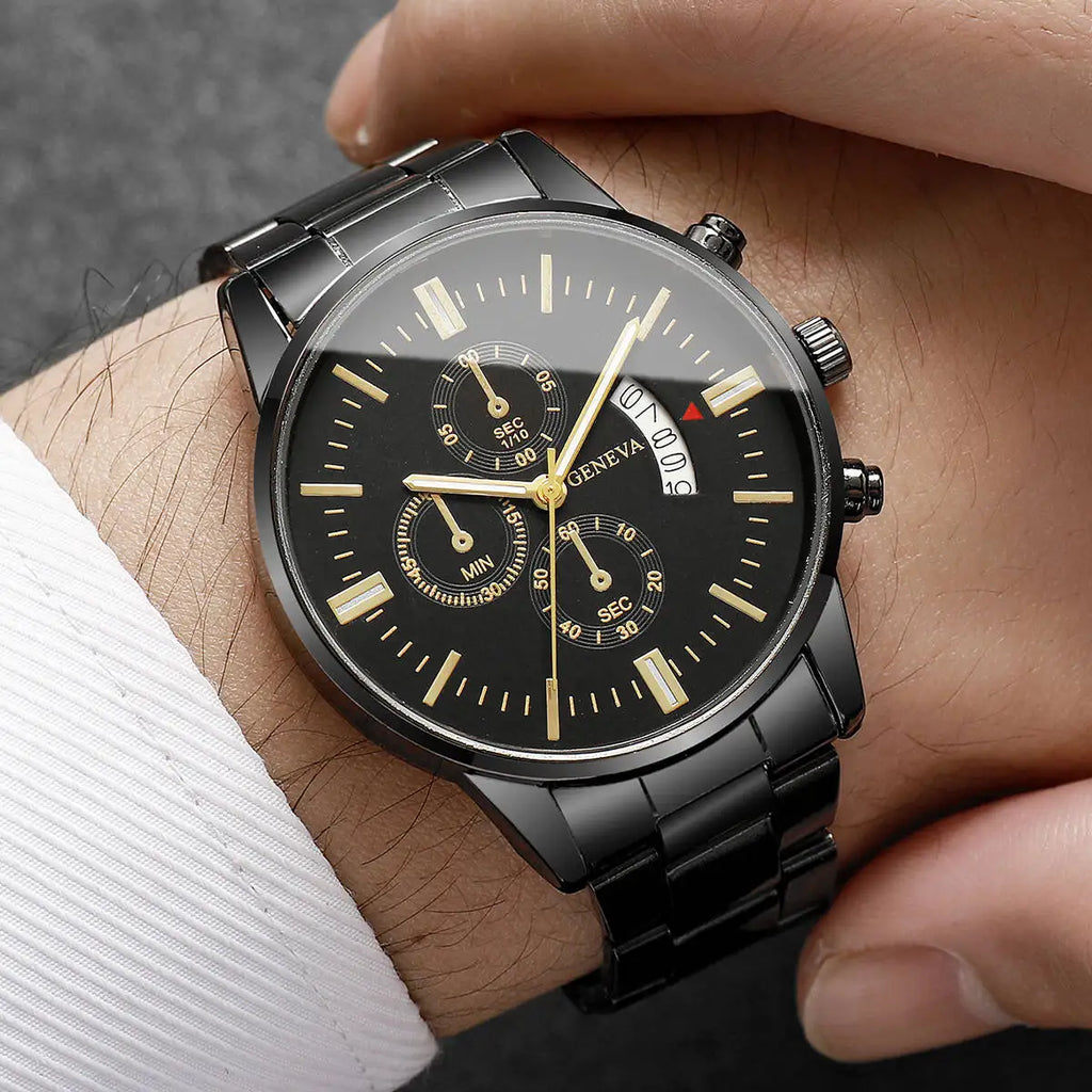 Black wristwatch with gold accents on a person's wrist against a dark background