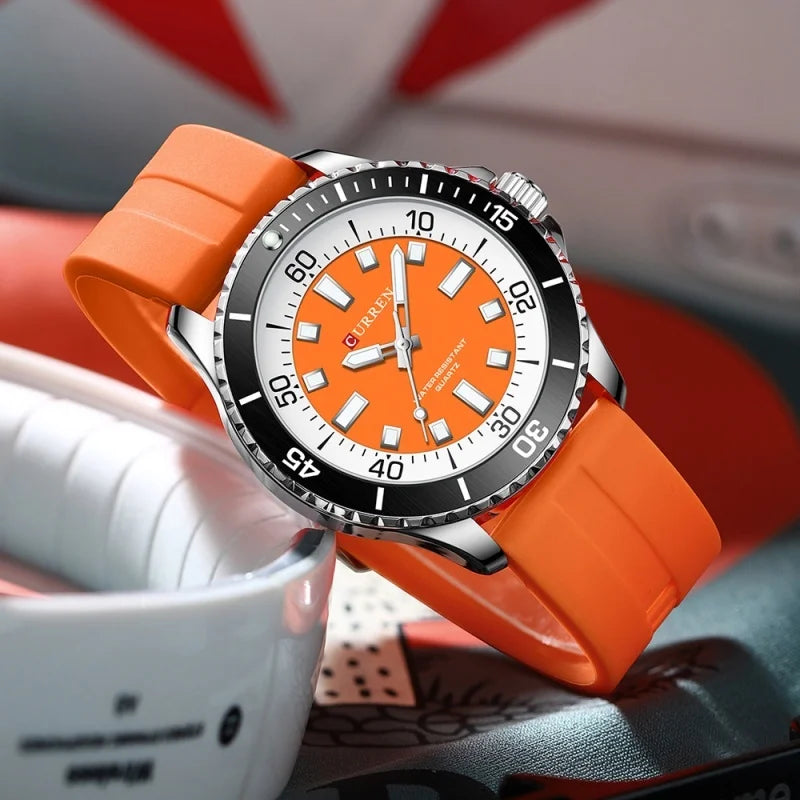 Orange watch with a white face on a colorful background