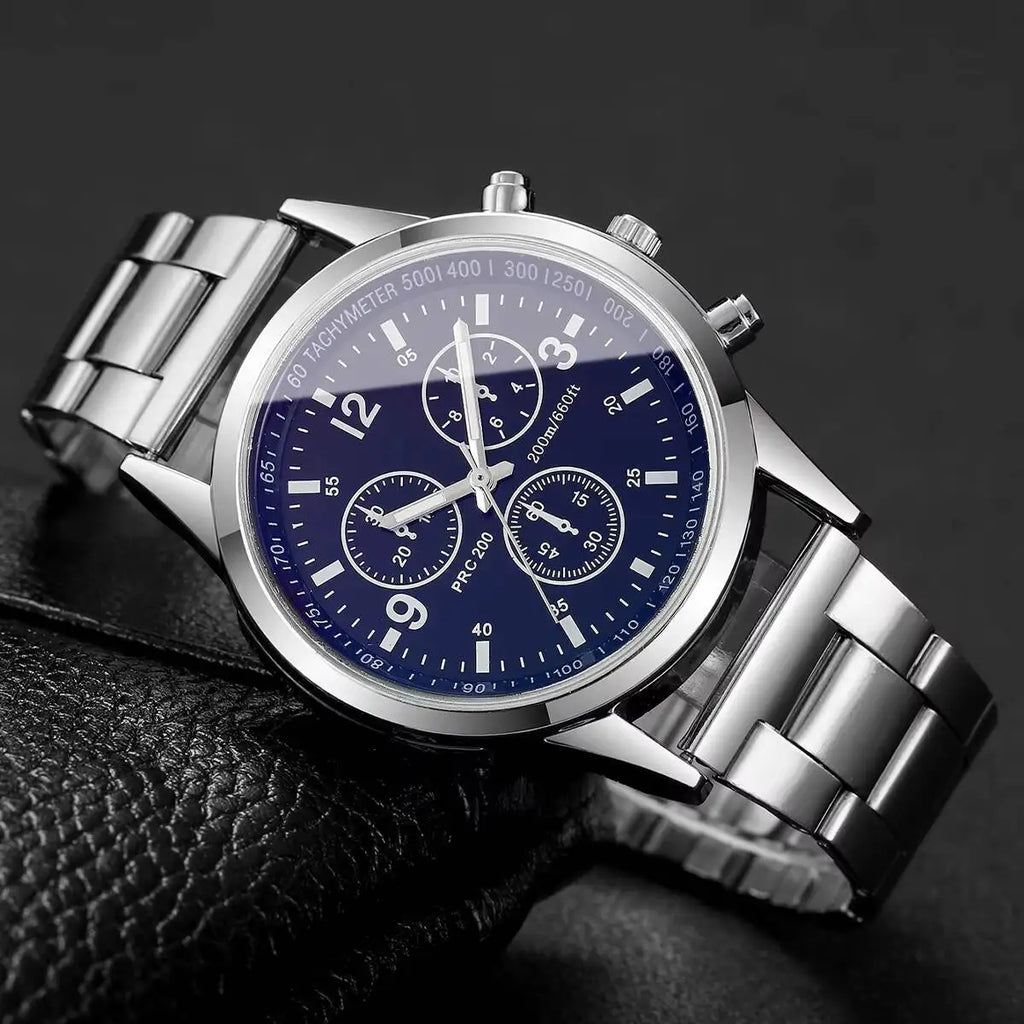 Silver wristwatch with a blue face on a dark background