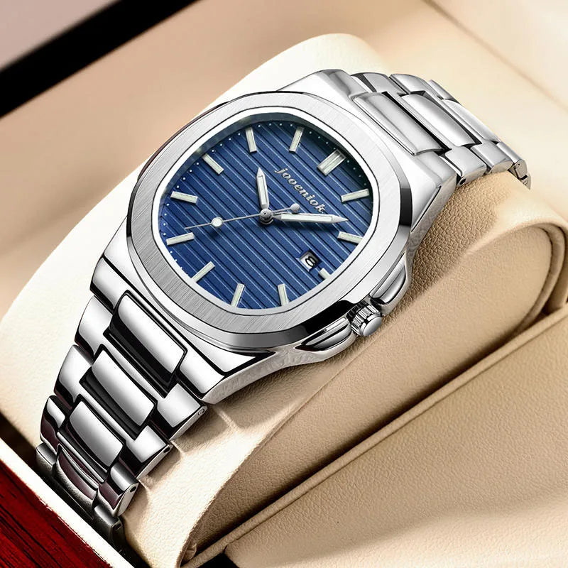 Silver watch with blue dial on a beige surface