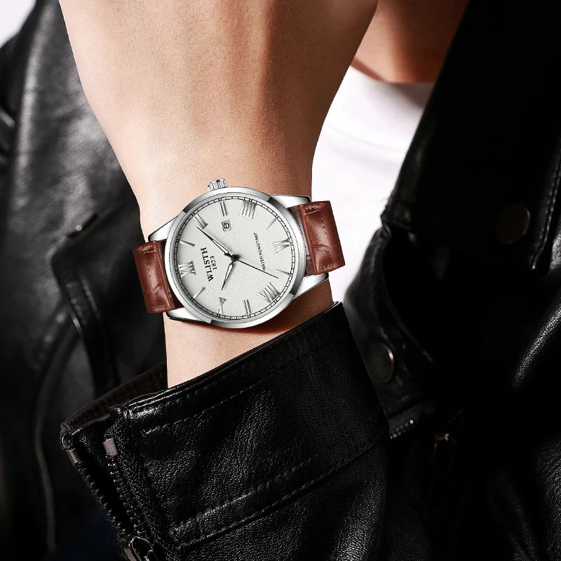 Close-up of a wrist wearing a watch with a brown leather strap, dressed in a black leather jacket.