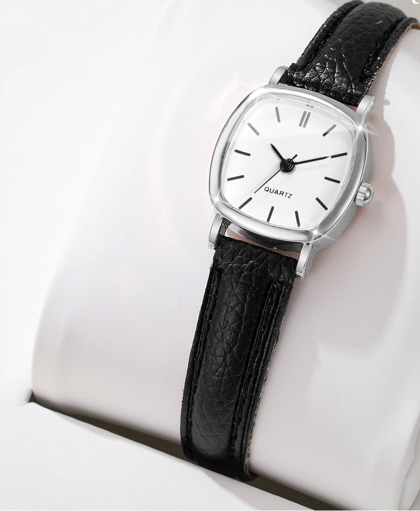 Black wristwatch with silver case on a white cushion, 'Boxes not include' text overlay.