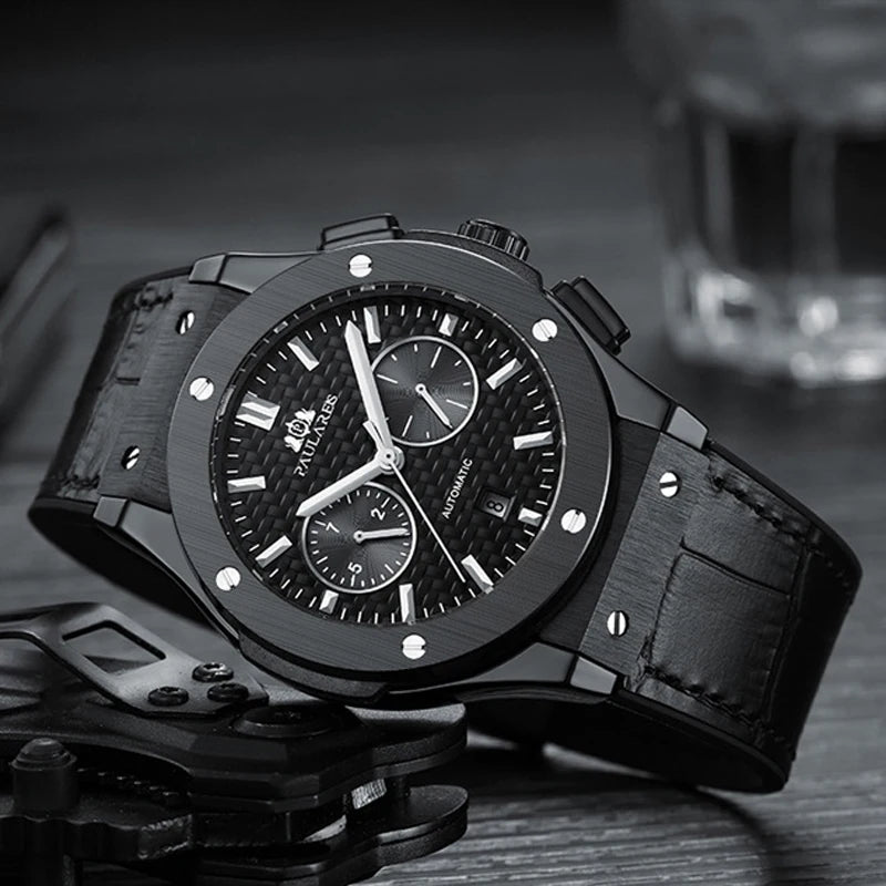 Black wristwatch with detailed face on a dark background