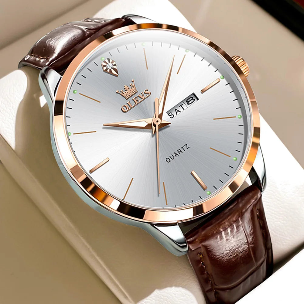 Watch with brown leather strap and silver case on a beige background
