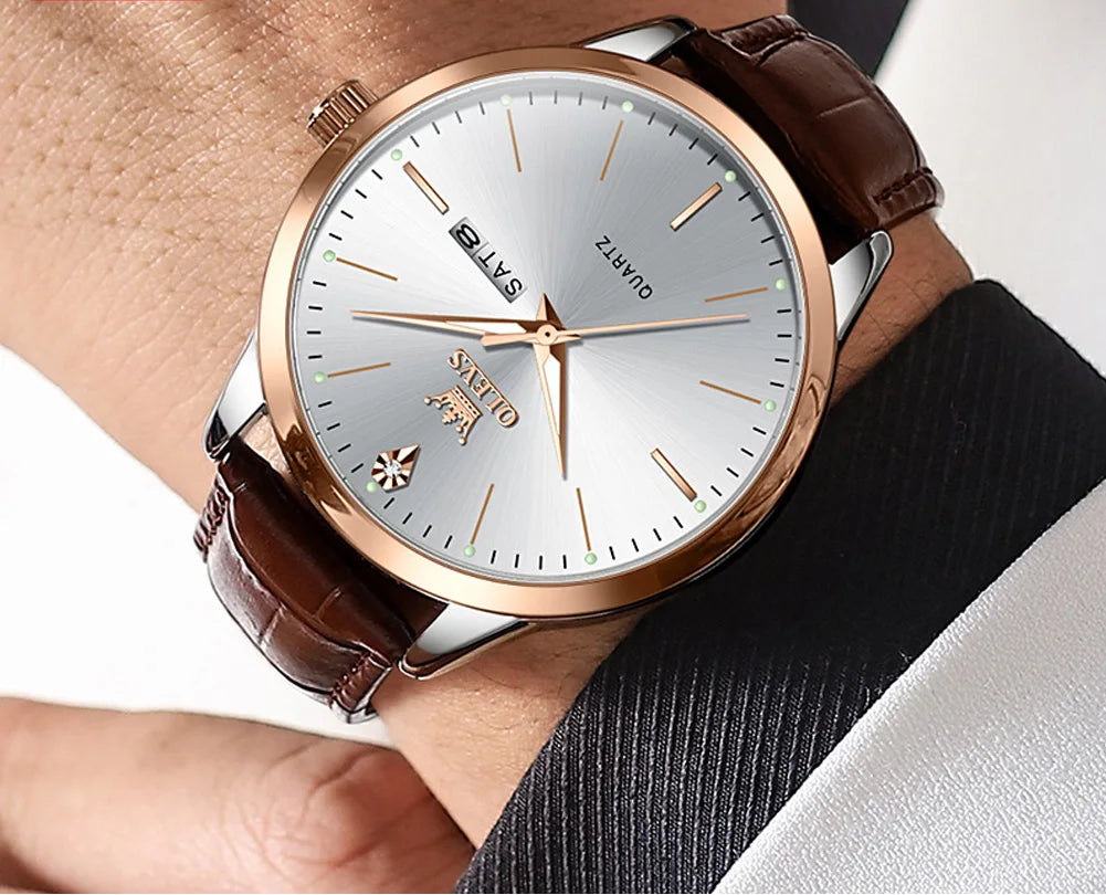 Watch with brown strap and white dial on a person's wrist, OLEVS brand visible.