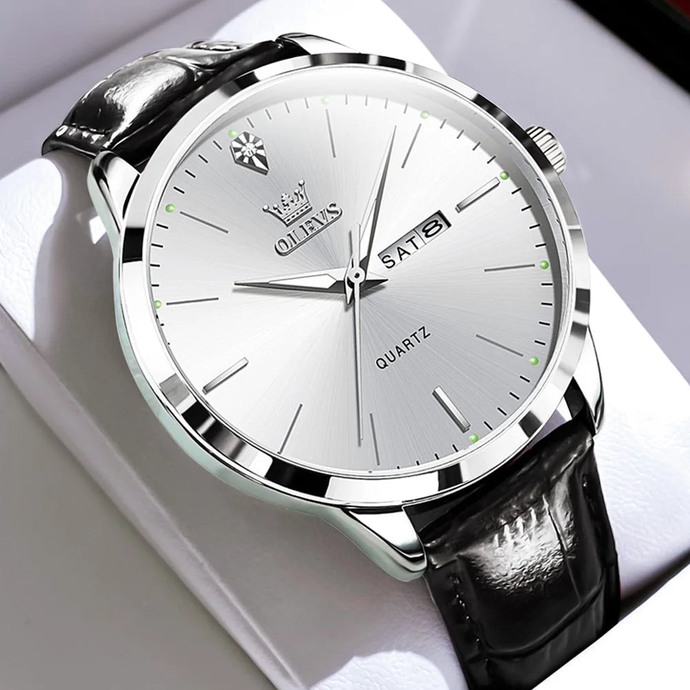 Silver watch with black leather strap on a white background