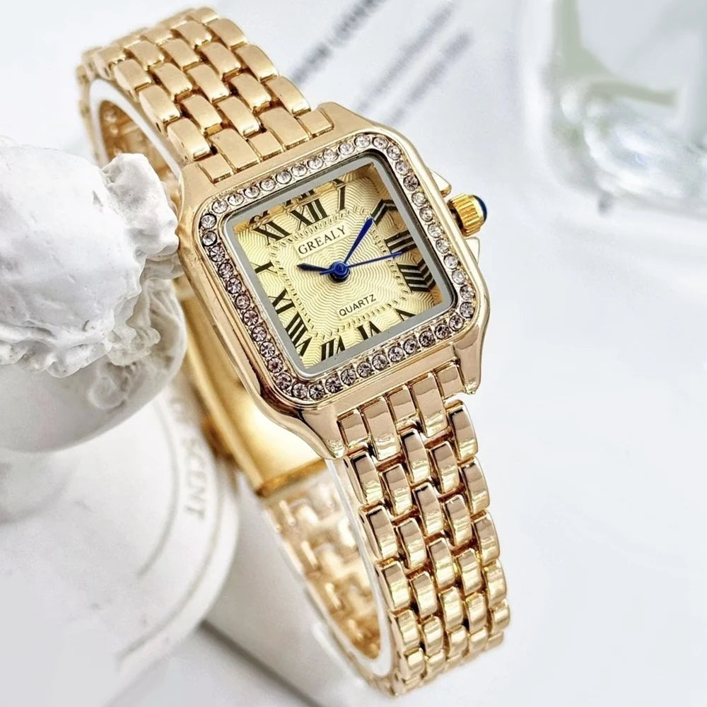 Gold wristwatch with decorative case on a white background