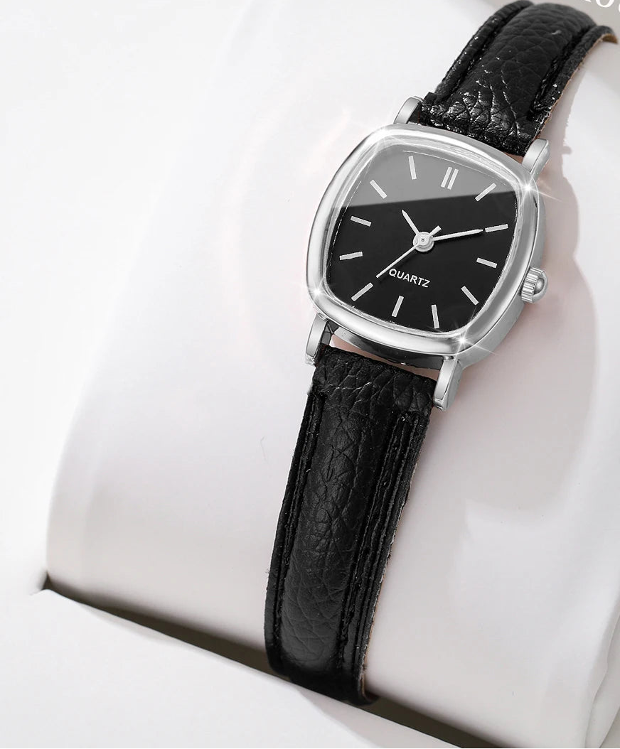 Black wristwatch with silver case on a white cushion, 'Boxes not include' text at the top.