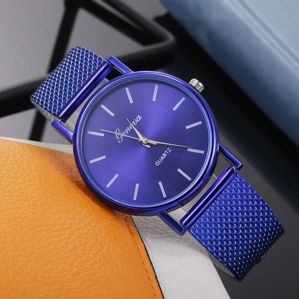 Blue watch with a textured strap on a gray surface
