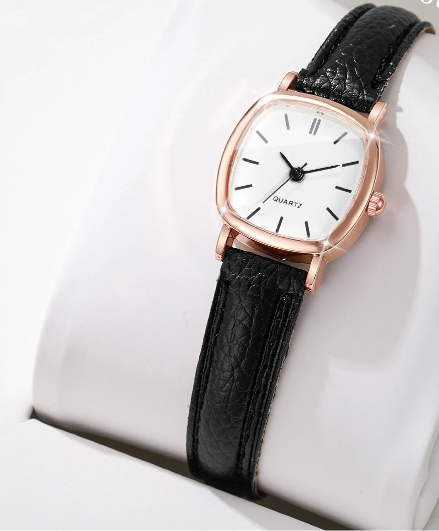 Black wristwatch with rose gold case on a white cushion, 'Boxes not include' text above.