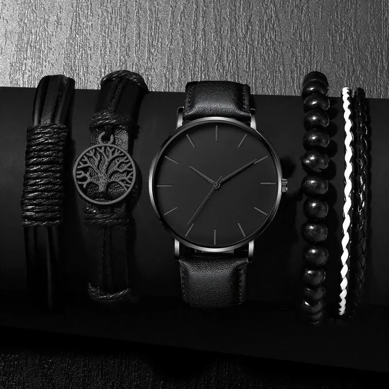 Black watch with various black leather straps on a dark background