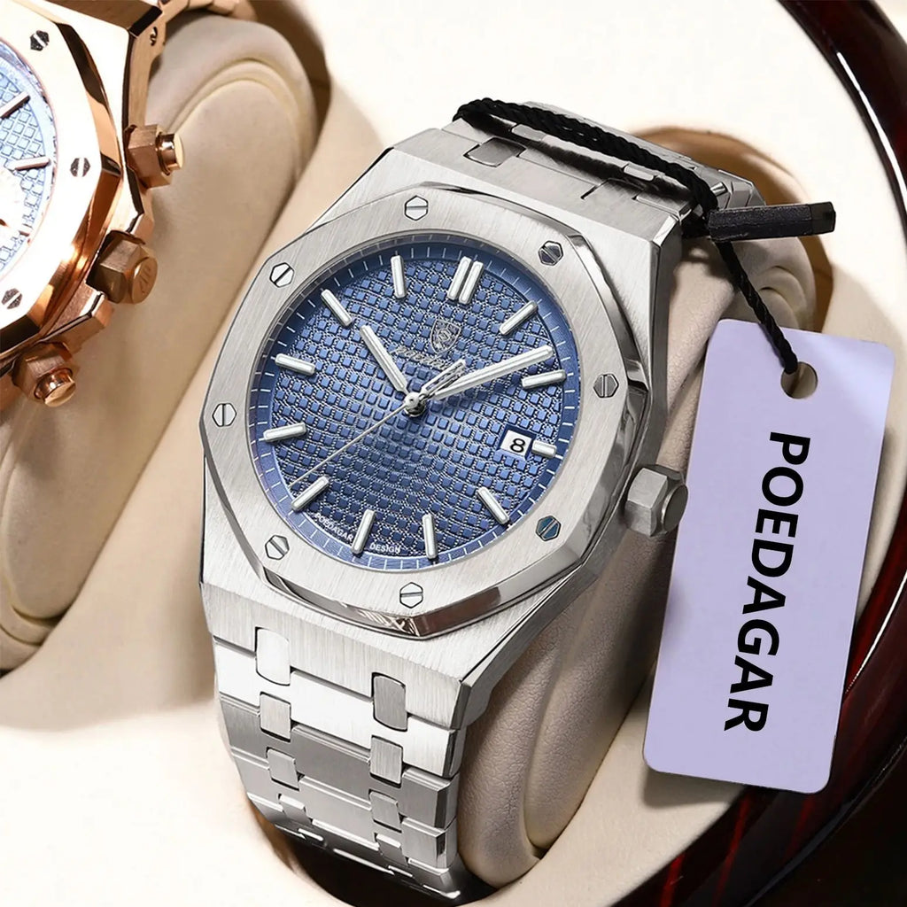 Silver watch with blue face and black strap on a beige cushion, branded 'POEDAGAR'.