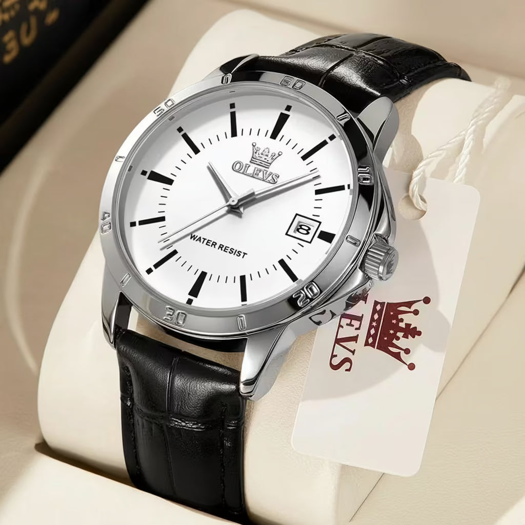 Olevs watch with black leather strap and white dial on a beige surface